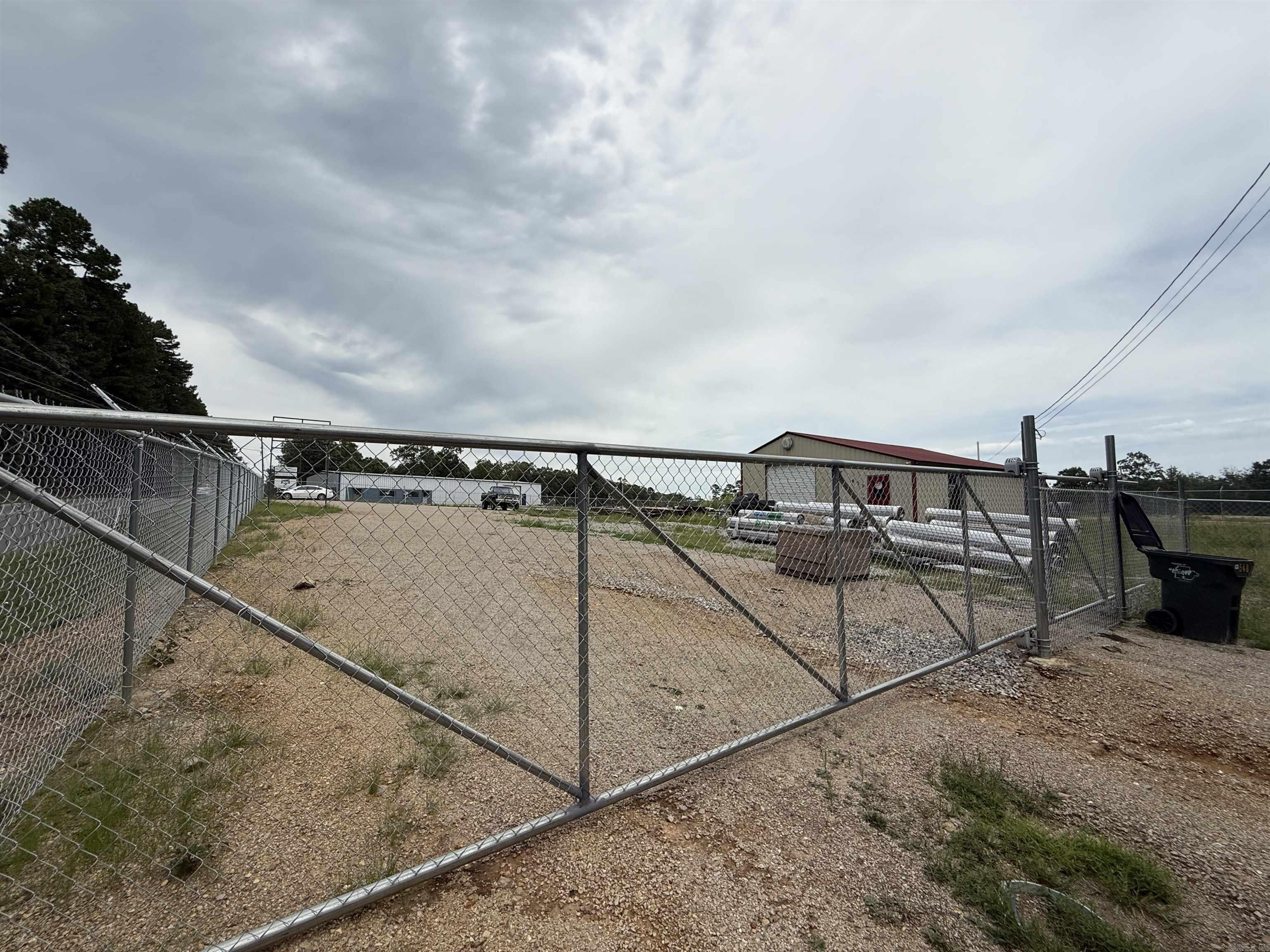 Prime Commercial Opportunity on 1.2 Acres Unlock the potential of this fully fenced and gated 1.2-acre commercial property, ideally located with approximately 200 feet of highly visible frontage on Fox Pass Cutoff in Hot Springs. Whether you're launching a new business or expanding an existing one, this versatile property offers a rare combination of security, accessibility, and infrastructure. At the heart of the property is a well-built 30' x 40' metal shop, perfect for automotive use, light manufacturing, or conversion into office or storage space. The level lot offers ample room for parking, storage, or future development — making it an excellent candidate for a self-storage facility, contractor yard, automotive repair center, or other commercial ventures. Key Features: 1.2 acres of flat, usable land Fully fenced and gated for security 200' of road frontage on Fox Pass Cutoff 30' x 40' metal shop with flexible interior use Easy access to major roads and only minutes from Hot Springs city center