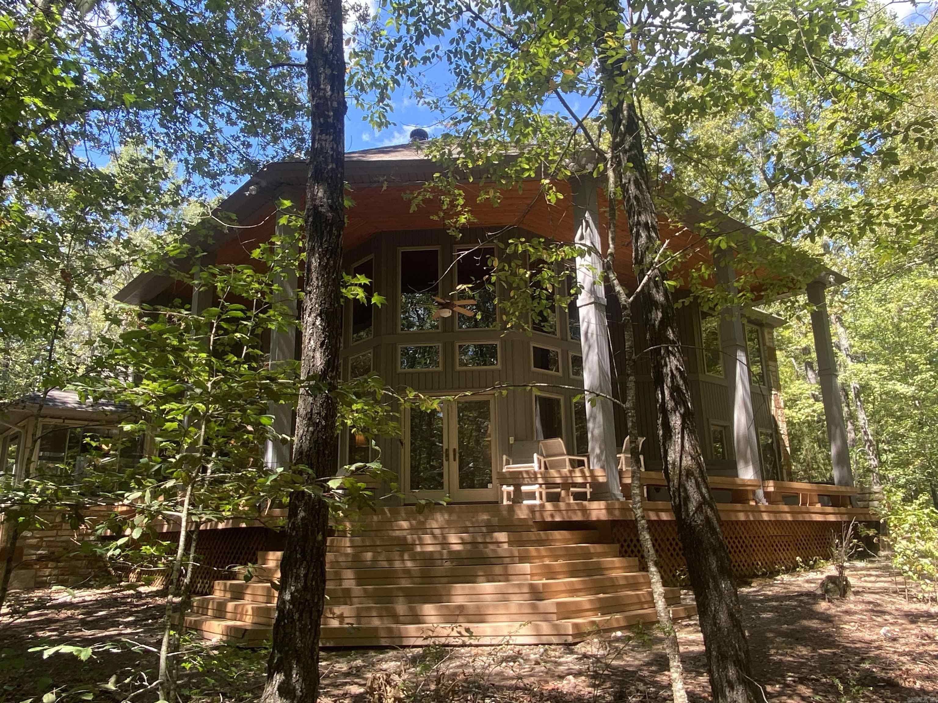 A RARE find at Lake Ouachita! This spectacular home & property is located off Twin Creek road for easy access to the boat launch. The 21 acre m/l parcel is bordered on two sides by the Corp of Engineers with the house approximately 800' to an arm of Lake Ouachita. This property is a prime investment spot for condos or a mobile home park near the Lake. The gated asphalt drive, winding down to the house, showcases the natural beauty of the acreage with large hardwoods, pines and dogwood trees. There is also a spring fed creek, a Silver mine and many other available building sites if you need more houses for your family, with no restrictions on building. A custom 3200 sq ft home is a showplace! Large Pella windows throughout the house accentuate the rooms to bring in lots of natural light. The great room has 20' wood accented ceilings that centers around a hand-crafted stone fireplace with a blower that will heat the whole house. Geo-thermal floor heating available, Generac generator, two sub-zero refrigerator drawers, composite deck, 20x30 shop with living quarters, sunroom, stone walkways, outdoor kitchen, extra bedroom & bath above the garage just to name a few of the extras!