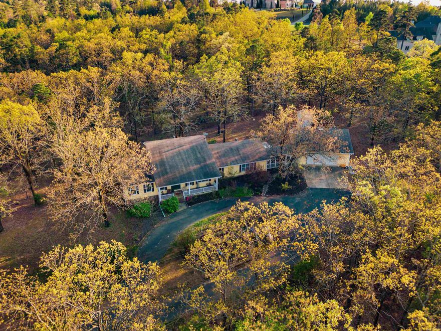 Discover a true hidden gem just 10 minutes from West Little Rock! This family oriented property offers the perfect blend of character, space, and privacy on a 4.11 acres. Featuring a main-level master and en suite separate from other bedrooms, a chef’s kitchen, hidden spacious pantry cabinets, custom made island, separate dining area, and a wonderfully oversized family room, this home is designed for comfortable living! Updates abound, including new gutters with guards, French drains, screened-in large breeze way for entertaining, a stylish herringbone patio, and a back yard Trex deck (off kitchen). The property boasts a massive detached double deep, 2 car garage with insulated overheard garage door for winter projects, versatile attic space (perfect for an office or guest quarters), additional outdoor sitting areas, 8 person storm shelter and raised garden beds. So many more details when you see in person! Transferable septic and crawlspace serivce policies included. A rare find—this well maintained property could be your next home!