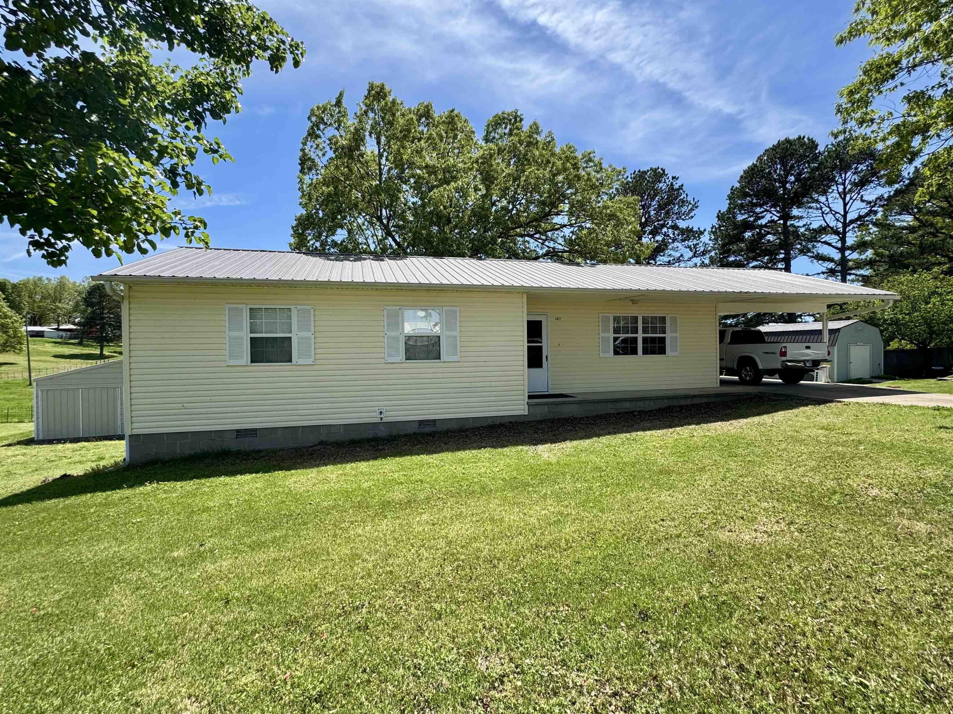 Welcome to this well-maintained 3-bedroom, 2-bathroom home, perfectly situated on a paved road in a convenient and accessible location. Inside, you'll find a thoughtfully laid-out floor plan with a spacious living area, a functional kitchen, and plenty of natural light. The master suite includes a private bath, while two additional bedrooms offer flexibility for guests, home office space, or for family. Step outside to enjoy the added benefits of a 24x30 shop, perfect for tools, projects, or extra storage. A 1-vehicle carport offers covered parking, and there's an additional storage room just off the carport for convenience.