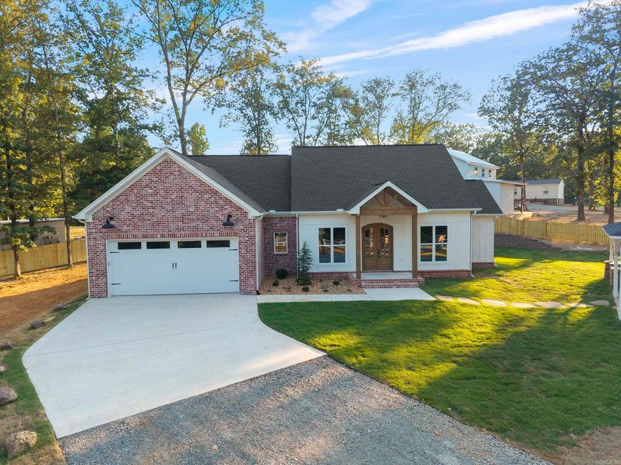 Situated on a peaceful 1.15-acre lot, this stunning new construction by Central Arkansas Construction offers the perfect blend of modern design and everyday functionality. Featuring 3 spacious bedrooms, 2.5 beautifully finished bathrooms, and an open-concept layout, this home is designed for comfortable living and effortless entertaining. The kitchen is a standout with quartz countertops, stainless steel appliances, custom cabinetry, and a generous walk-in pantry. Durable and stylish flooring flows throughout, leading to a cozy living area, a dedicated mudroom, and a laundry room. The luxurious primary suite includes a tiled shower, soaking tub, and elegant finishes, while the guest baths are equally well-appointed with custom tilework. Step outside to enjoy both a covered patio and an additional detached covered outdoor living space, perfect for relaxing or hosting gatherings. The fully fenced yard adds privacy and peace of mind, and a built-in safe room offers an extra layer of security. Don’t miss this rare opportunity to own a thoughtfully crafted home in a serene setting. Agents, please see remarks.