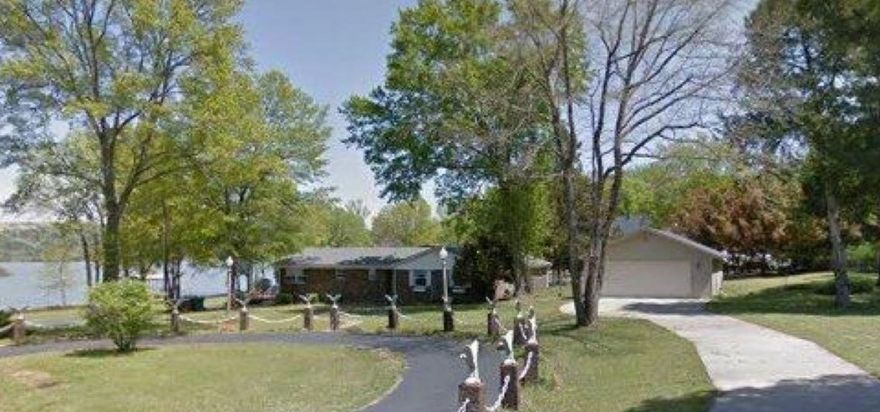 Lake front home, has private 10ft deep pool with new diving board and water slide huge composite deck, boat dock and lift, 2 outdoor shops, fenced in yard and so much more! Home boasts new floor, new kitchen, has paved driveway, Leaf Filter gutters which has a lifetime transferable warranty. This lake front home is at the end of its own road! Over 1 acre of Lake front home with a pool and a shop! Huge Home, room for everyone! Come and take a private tour today!