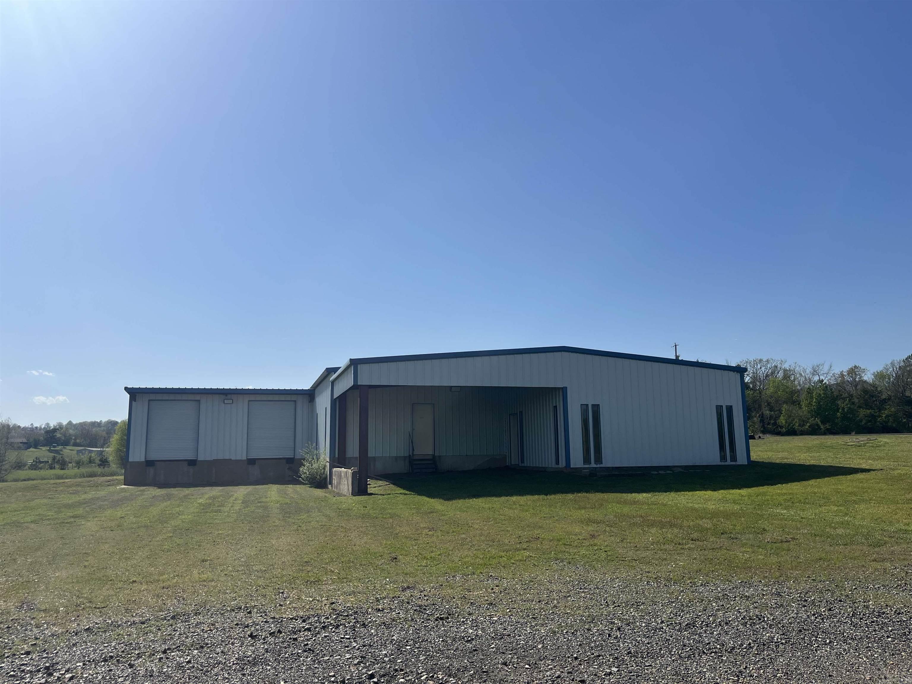 Business Opportunity!!! 3,540 sqft. warehouse w/2 acres! Recently remodeled with new electrical service and wiring! 220 and 100 power! City water with new meter installed, city sewer available! Warehouse with 3 bay doors w/access to docking and loading areas. 500 feet overhang for covered parking. Re-enforced concrete foundation is 4 feet thick!