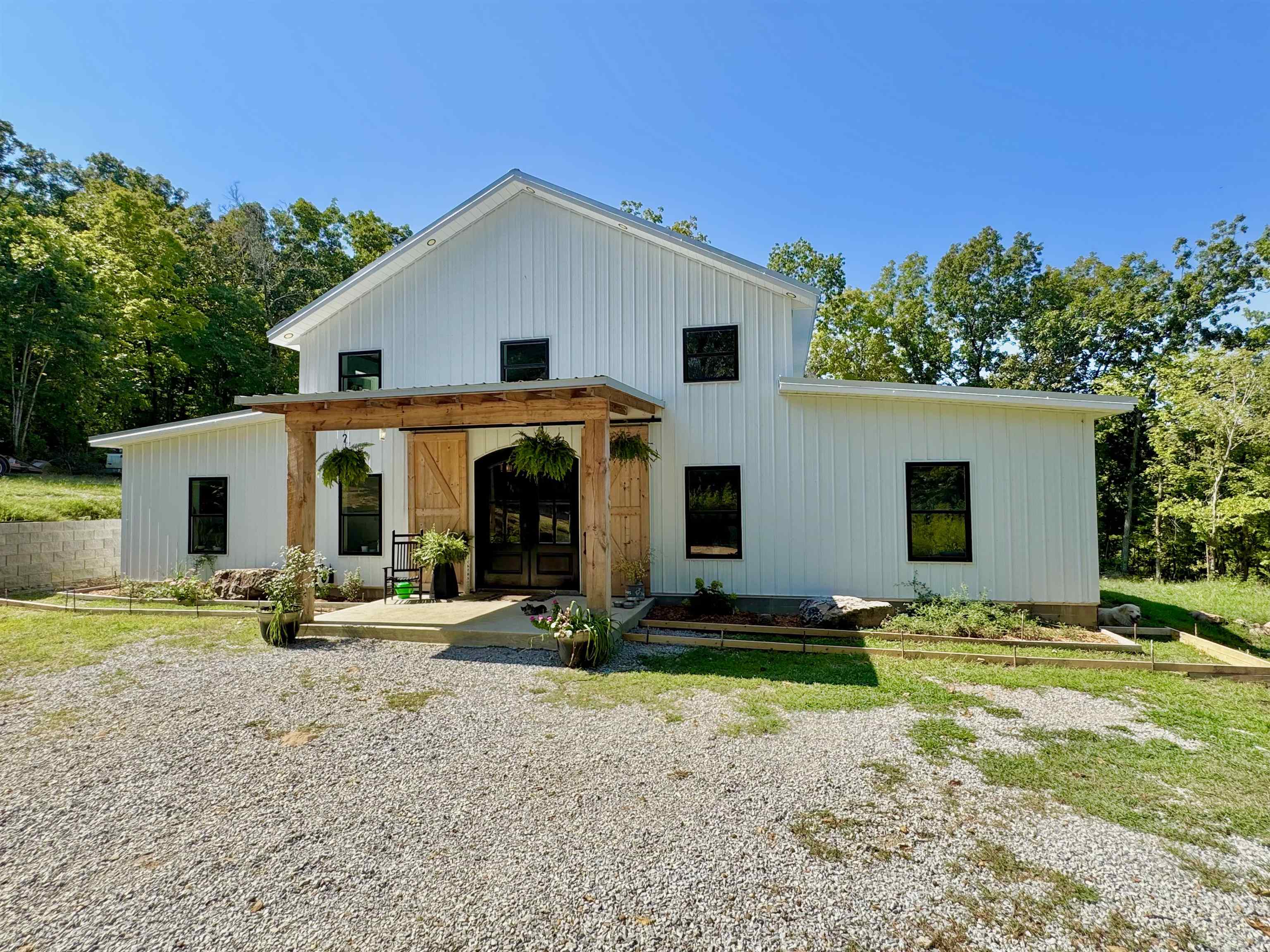 Discover the perfect blend of modern comfort and country charm in this stunning custom barndominium style home on 5 beautiful acres. Designed with an open floor plan, the kitchen features a large granite island, commercial-sized cook stove, and a dedicated coffee bar, & pantry. The main floor offers two master suites, each with a full bath attached with a walk-in tile showers. Upstairs, you’ll find a game/family room along with two additional bedrooms and a full bathroom, making this home ideal for families or guests! One of the home’s standout features is the 1,180 sq. ft. attached garage, a dream space with endless possibilities. Whether you need storage for an RV, a spot to shoot hoops, a workshop, or simply extra space, this garage has it all! Located close to Downtown Mountain View & the White River!