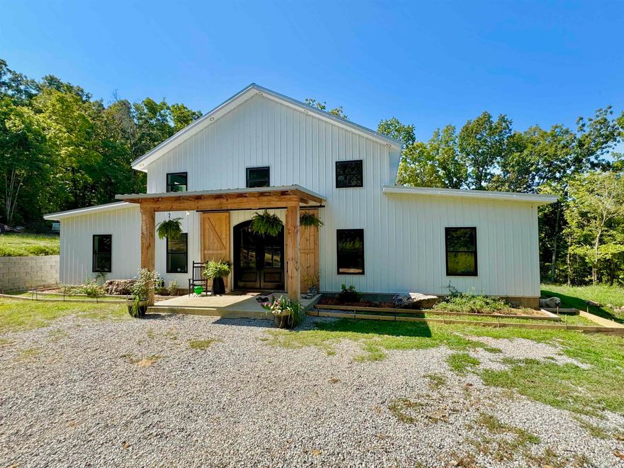 Discover the perfect blend of modern comfort and country charm in this stunning custom barndominium style home on 5 beautiful acres. Designed with an open floor plan,  the kitchen features a large granite island, commercial-sized cook stove, and a dedicated coffee bar, & pantry. The main floor offers two master suites, each with a full bath attached with a walk-in tile showers. Upstairs, you’ll find a game/family room along with two additional bedrooms and a full bathroom, making this home ideal for families or guests! One of the home’s standout features is the 1,180 sq. ft. attached garage, a dream space with endless possibilities. Whether you need storage for an RV, a spot to shoot hoops, a workshop, or simply extra space, this garage has it all! Located close to Downtown Mountain View & the White River!