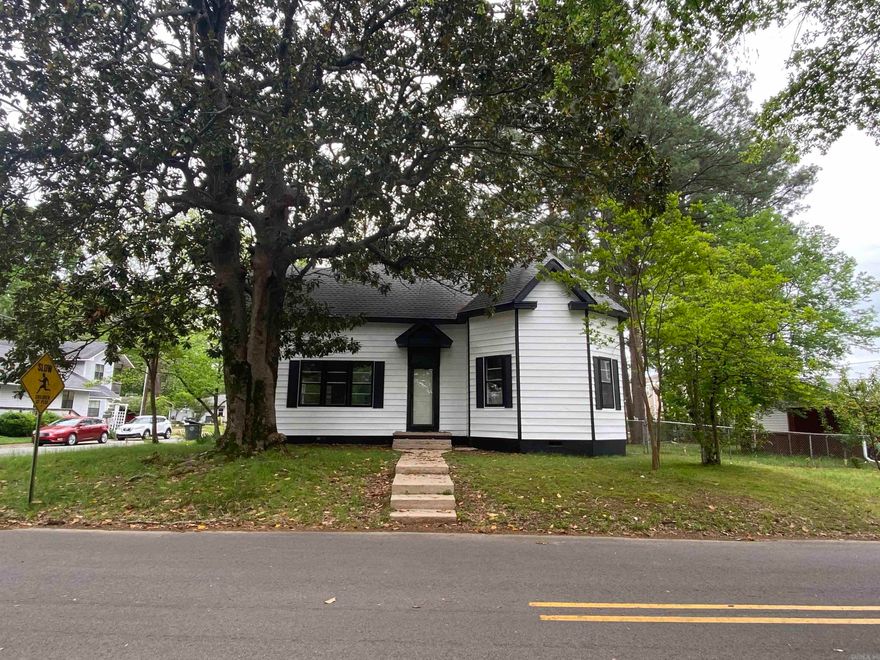 Wonderful Victorian farmhouse design that's jammed packed with updates and original touches.  New HVAC and hot water tank in 2020.  New roof and plumbing in 2021 and new electrical in 2024.  New wainscoting added throughout the main living areas of the home and original transom windows add a touch you don't see in a new build today.  Spacious kitchen with gas range, built ins and lots of cabinet space.  Original fire place in bedroom/study with bay window.  Super high ceilings in main living space and original beadboard ceilings.  New electrical panel, one car garage with workshop space on .48 Acres in town on a corner lot gives access to the large yard.  Within walking distance to the middle school 2 blocks away.  All on one level.