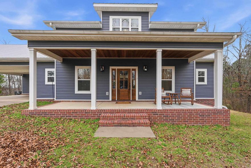 Built in 2018, this 2,664 sq ft home sits on 5.61 acres on the lake, positioned on a hill with a high level of privacy. The primary bedroom is on the main level, with two bedrooms, a full bath, and a bonus room upstairs. The home includes 2.5 baths, walk-in closets in all bedrooms, and multiple pantries and storage closets throughout. The carport includes two enclosed storage rooms, and a large front porch offers ample space for seating or a porch swing. Leaf-guard gutters are installed