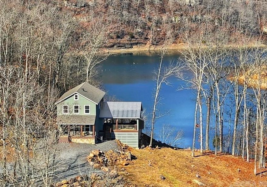 This Property checks a lot of boxes ..*BOAT SLIP *LAKEFRONT *PANORAMIC LAKE VIEWS *Newly Built Home *ACREAGE w/7 ACRES!!!! Great Location with Boat Slip in the Watersedge Community Dock (Slip #12) located in a protected cove off of Middle Fork on Greers Ferry Lake with easy access from the dock parking lot. Your guests will be Amazed as they pull up to park & immediately see the Gorgeous Views! It never gets old driving up to this home as you wind through the trees up the driveway & then the views open up as you pull up to the Lake House! Main bedroom on first floor w/ 3 other bedrooms upstairs off of the Gameroom (that also has lake views). Hand scraped 3/4" Solid hickory wood floors thoughout the home. Main level has an open kitchen/living room combo with more lake and mountain views plus walkout door onto the 24x32 covered porch w/gas fireplace (gas logs not present) where you can unwind from a day on the lake. (SEE LINKS FOR VIRTUAL TOUR AND VIDEO)
