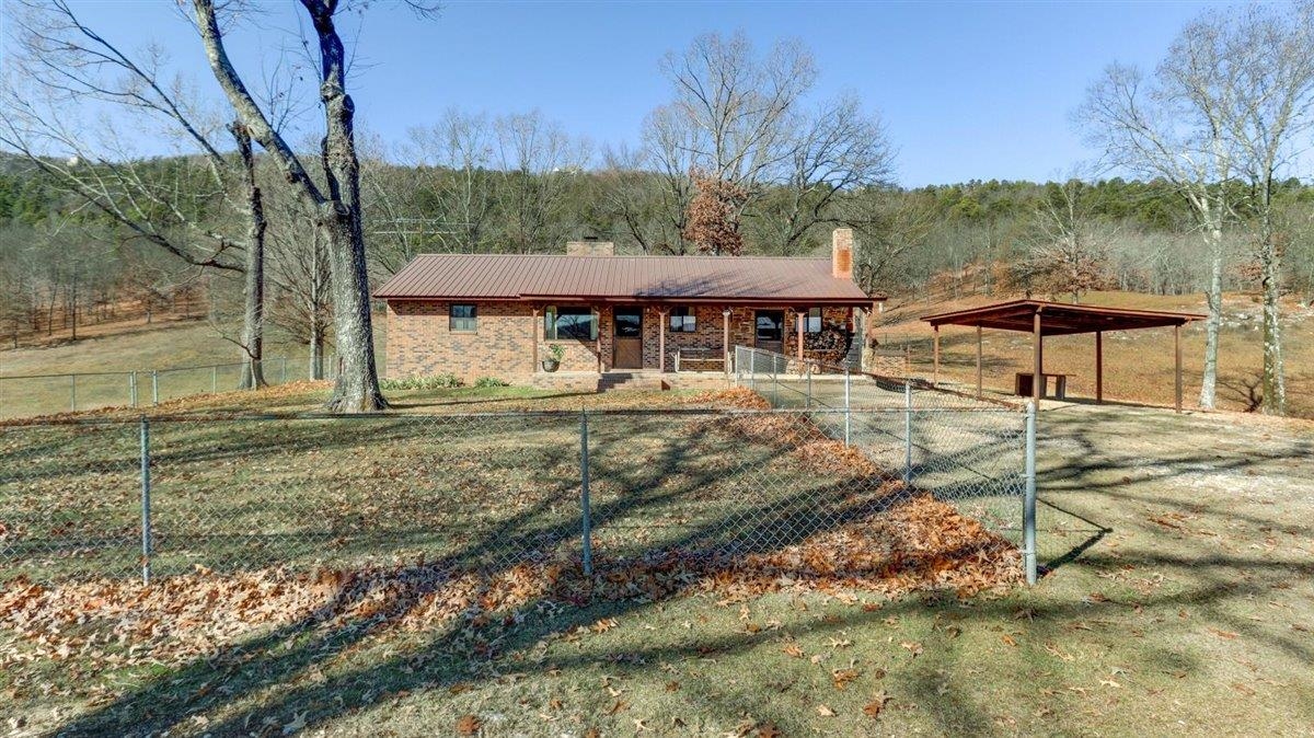 Experience rustic elegance on 40 acres of secluded paradise. The robust home boasts extra roof trusses & a double-layered metal roof w/lifetime warranty for savings and security, updated plumbing less than 5 years. The primary bedroom features an Ashley Brand wood stove for cozy nights. 2 septic systems ensure reliability. A gated entrance with a brick foundation adds security. The vast property offers hunting opportunities & a stocked ¼ acre pond. The 30x30 workshop is a hobbyist's dream, with hot/cold water, wood heater, emergency generator connection, & 120/220 volts. A commercial-grade well made of stainless steel Grund Brand highlight quality. The fully fenced property is suitable for livestock. Includes 4 Angus Cross Beef cattle, 15 chickens, and 15 guineas. Conveniently located near the mall, Oaklawn Horse Race Track, and 4 lakes, with easy access to Jack Mountain WMA for hunting, 4 wheeling, and other recreation. A new main road is under construction promises a smoother future passage. Nearby Lakes - Hamilton, Degray, Catherine, and Ouachita; rivers; and abundant nature, this property offers a perfect blend of comfort, utility, and serenity.