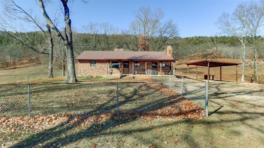Experience rustic elegance on 40 acres of secluded paradise. The robust home boasts extra roof trusses & a double-layered metal roof w/lifetime warranty for savings and security, updated plumbing less than 5 years. The primary bedroom features an Ashley Brand wood stove for cozy nights. 2 septic systems ensure reliability.  A gated entrance with a brick foundation adds security. The vast property offers hunting opportunities & a stocked ¼ acre pond. The 30x30 workshop is a hobbyist's dream, with hot/cold water, wood heater, emergency generator connection, & 120/220 volts. A commercial-grade well made of stainless steel Grund Brand highlight quality.  The fully fenced property is suitable for livestock. Includes 4 Angus Cross Beef cattle, 15 chickens, and 15 guineas. Conveniently located near the mall, Oaklawn Horse Race Track, and 4 lakes, with easy access to Jack Mountain WMA for hunting, 4 wheeling, and other recreation. A new main road is under construction promises a smoother future passage.  Nearby Lakes - Hamilton, Degray, Catherine, and Ouachita; rivers; and abundant nature, this property offers a perfect blend of comfort, utility, and serenity.