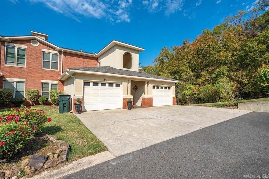 This gated, secluded, peaceful, quiet, and well maintained two bedroom-two bath condominium is ready for a new family! This top floor unit has a large patio with views of Lake Hamilton, the rolling hills, and is wooded on one side giving you privacy on your additional grilling patio complete with a gas grill with gas hook up. This condo offers a Bruno chair lift, HVAC new (2021), new roof, (2024), new flooring (2019) recent interior paint, newly painted front steps and back/side deck floor and rails.  A one-car garage and additional storage room on the back patio offer plenty of storage options.  The complex offers a pool to spend your time relaxing and keeping cool in the summer months. The condo has a primary suite with built in shelves and fireplace and the bath boasts an extra large jacuzzi tub, a walk-in shower, multiple cabinets, and a large walk-in closet. It also offers doors that open to the patio with lake and mountains views.  The open floor plan is great for conversation or entertaining.   The complex also offers a private boat ramp for your use. This condo is move-in ready!