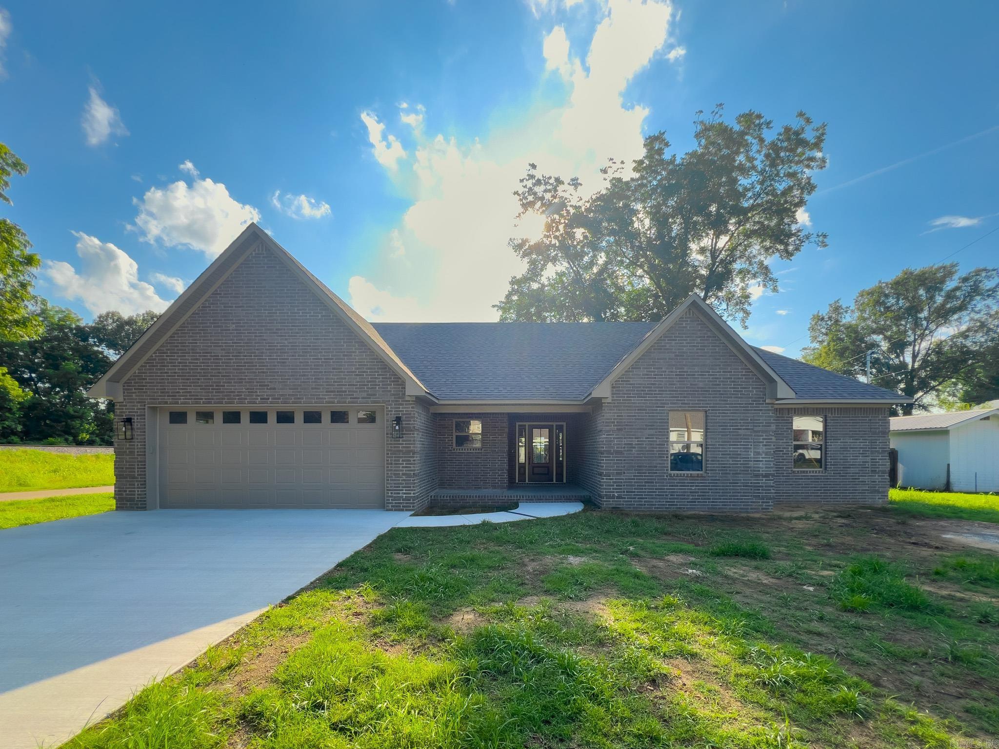 Brand New & Beautiful! This stunning 3 bed, 2 bath home offers timeless style with its brick exterior and chic interior finishes throughout. Step inside to an open-concept layout featuring a vaulted, beamed ceiling, a cozy brick fireplace, and abundant natural light. The spacious living and dining areas flow seamlessly into a dream kitchenācomplete with stone countertops, shaker-style cabinetry, large pantry, and plenty of prep space. The primary suite is a true retreat with a bath showcasing a double vanity, gorgeous tile-surround soaking tub, and a custom walk-in closet. Two additional bedrooms and a full guest bath round out the smart floor plan. Step out back to enjoy the oversized covered porchāideal for grilling or relaxing. From the fresh finishes to the thoughtful layout, this brand-new home checks every box. Don't miss your chance to make it yoursāschedule your showing today!