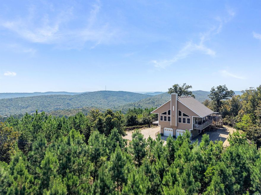 Check out this gorgeous mountaintop home overlooking 138 acres in the Fountain Lake area! Experience total privacy and seclusion without sacrificing convenience -- Walmart Supercenter on Hwy 7 North is only 4.6 miles away. This property comes fully furnished and includes a hot tub, outdoor kitchen, multi-level decks, and hidden safe room. Located outside of city limits. Perfect for a family residence, hunting retreat, or short term rental (no permit required).
