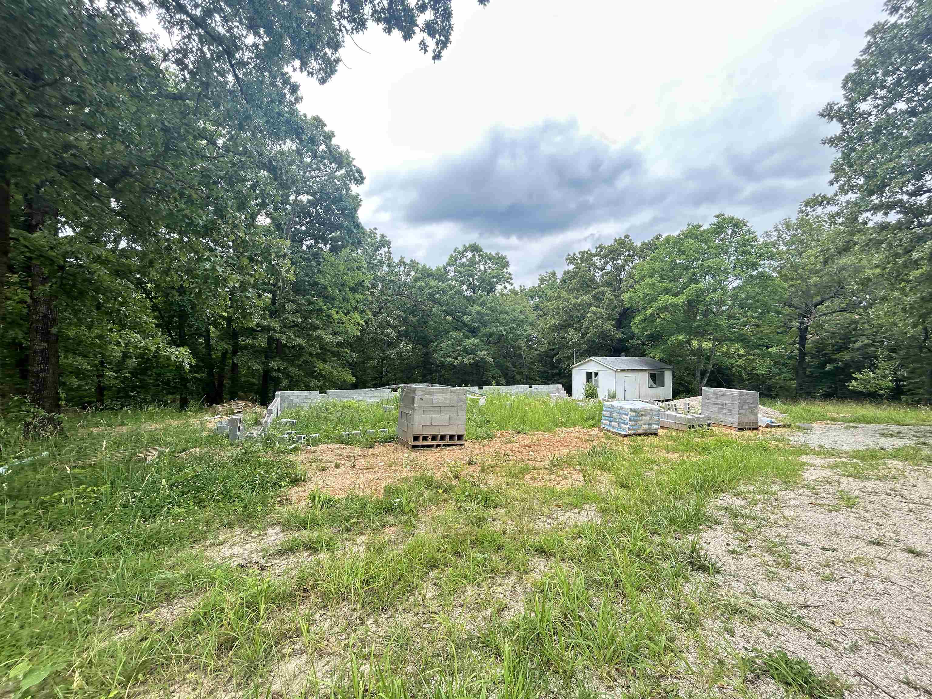 Build your dream home or weekend cabin on this 2-acre lot with a 60x40 foundation started. City water meter and sewer grinder pump on the property. Manufactured homes are allowed. Minimum square footage is 800 Sq ft. Located on a paved city road. Has a small outbuilding. Partially fenced. Several large trees are scattered on the property. Minutes to Hardy and Spring River for swimming, fishing and boating. Minutes to the Harold E. Alexander Wildlife Refuge for hunting.