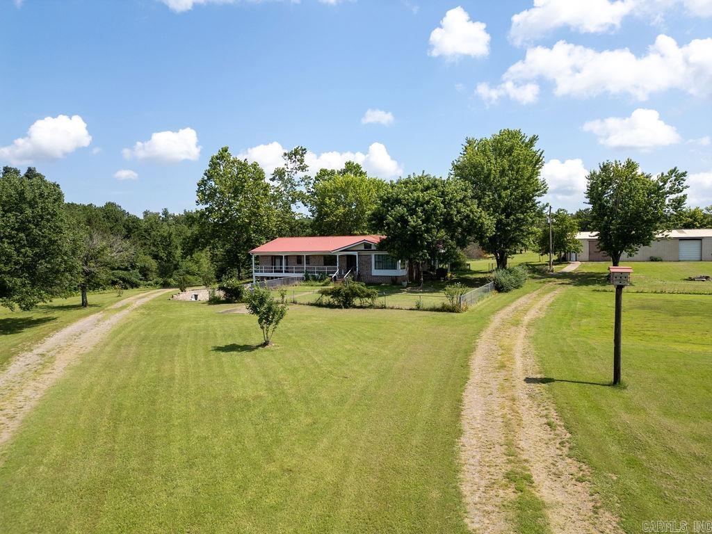 Embrace true farm life on this peaceful 28-acre property with woods and a pond. This 4-bedroom, 2-bath home includes a full basement and a shop with a concrete slab and electricity—ideal for fixing equipment, storing tools, etc. You’ll have plenty of room for livestock, a big garden, and direct access to nature.