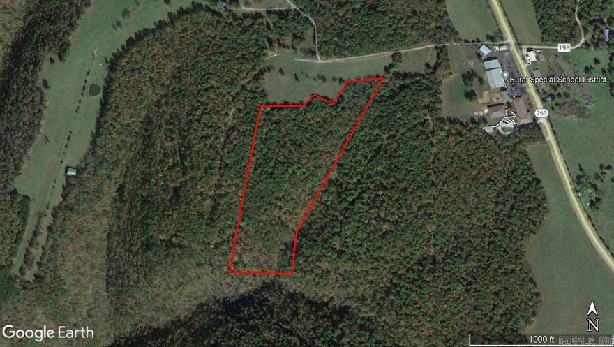 15+/- wooded acres with large timber, small creek, bluffs and rock outcroppings. Excellent hunting with several possible building sites.