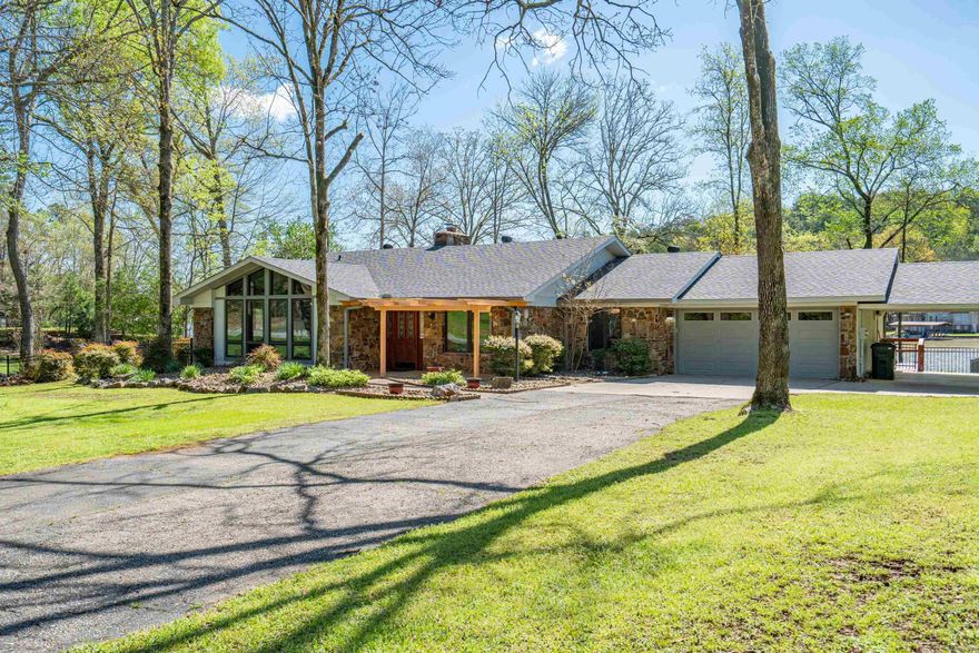 Lake-life entertainer's dream! Enjoy the summer in this charming, well-maintained 3-bedroom, 2-bathroom Lake Hamilton lakefront home in a no-wake cove. Situated on a walk out level lot, the exterior offers an expansive partially covered deck for those hot sunny days, fenced in backyard, covered boat dock, swim dock, double jet ski ramp, hot tub and storage building. During the winter months cozy up to one of the fireplaces while you play a game of pool and watch the game. Interior features also include granite countertops, stainless appliances, wine fridge, laundry room, living room vaulted ceiling, large sunroom and abundant natural light. Updates include new HVAC and roof in 2024. Electric panel wired for portable generator. Don’t miss out on this one that checks all the boxes! Call today to schedule a showing or for more information.