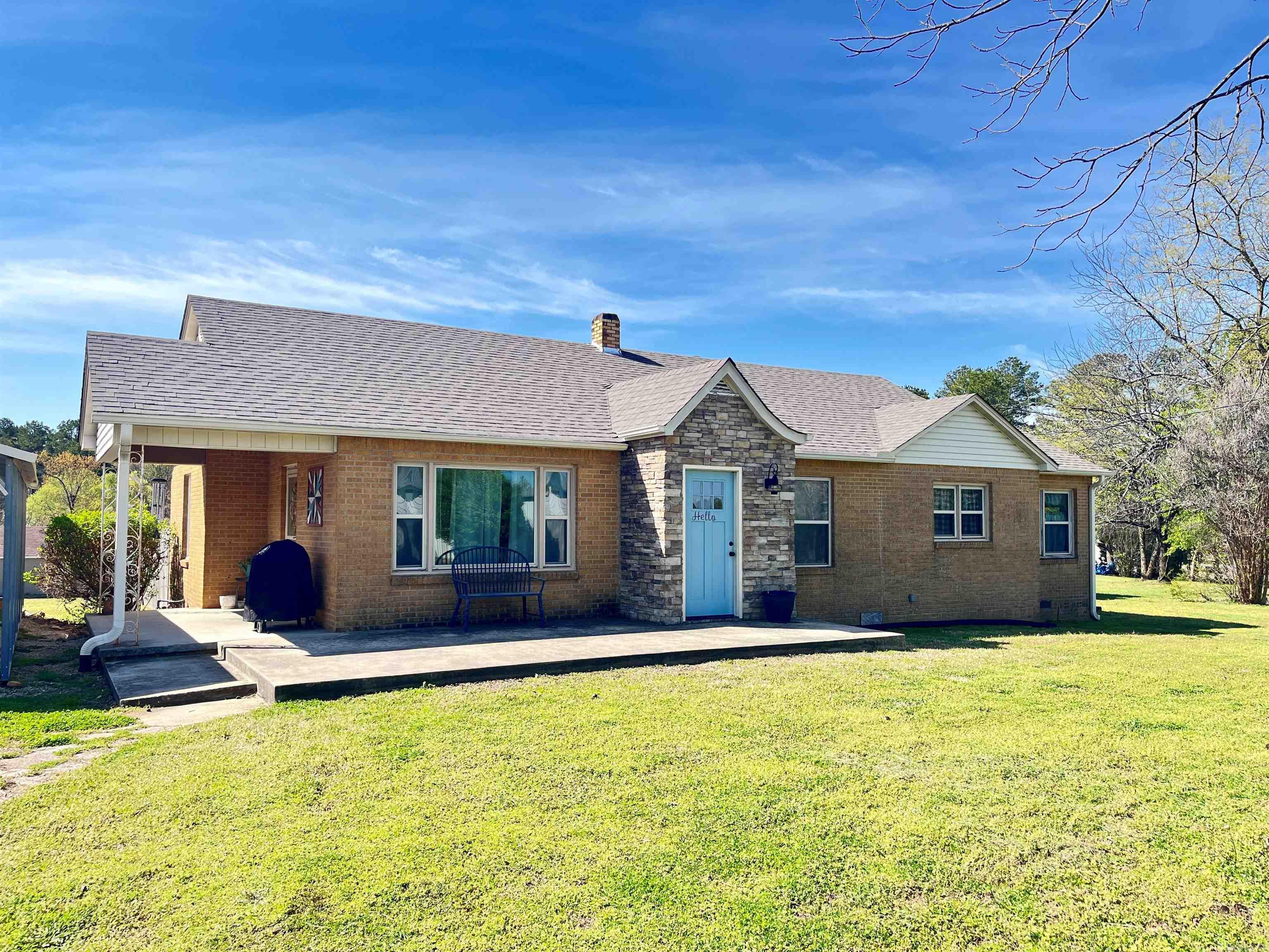Farmhouse charmer just inside the city limits! 3BR/ 1.5 bath home on 1.46 acres with privacy fenced yard, wood deck, metal carport, 18x24 shop with electric, concrete floor and full bath and additional 12x14 storage building. Refinished hardwood floors, shiplap, wood ceilings, barn doors and so much more! Full kitchen remodel in 2016, fence & HVAC 2017, new windows in 2020 and roof in 2024. See agent remarks.