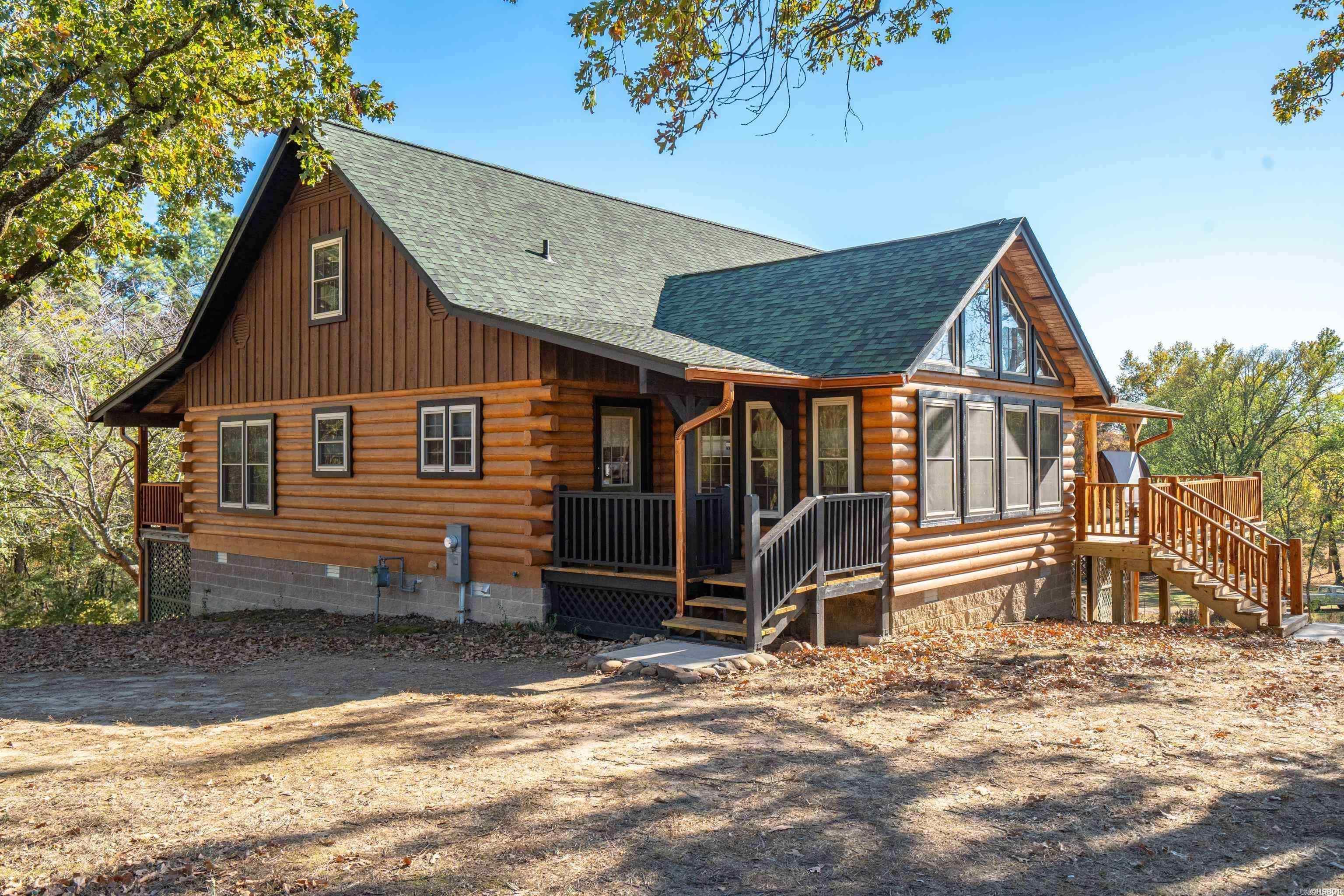Experience city living in this beautiful 2,800+/-Sqft log home. Close to all the amenities Hot Springs has to offer is this 3 Bedroom, 2.5Bathrooms, bonus room, granite, wood floors, loft area, and claw foot bathtub. New light fixtures, gutters, decks, custom new railings, concrete landings, and much more. New roof in summer of 2023. Spacious 2.5 car garage and an additional dry storage area under the house. Nestled on just over an acre corner lot, this luxurious style log home has plenty of space to expand or even add shop. Don't miss this opportunity to own a luxurious lifestyle log home in the heart of the city.