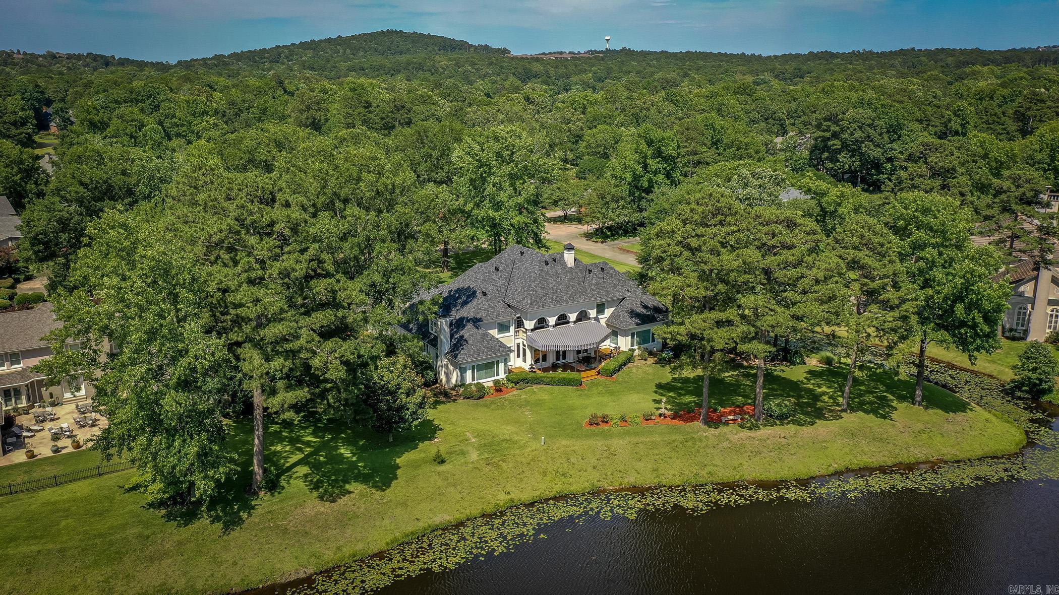 Architecturally designed home backing to Founders Golf Course is sited on 1.17 acres in The Chenal County club. The main floor features a foyer, living room, dinning area, den, kitchen, office, master suite, guest suite, and stunning sunroom. Kitchen totally remodeled with custom cabinets, and granite counters. Upstairs has four bedrooms with three full bath, game room, and additional French veranda. Every room is oversized/perfect, and every window looking out onto the water and golf course. Additional features include a butler's kitchen, 4 car garage, fountain, and circular driveway. Precious builder ( Randy Ferguson)ās home ā French Villa Style Living featured in " Life in Chenal"!