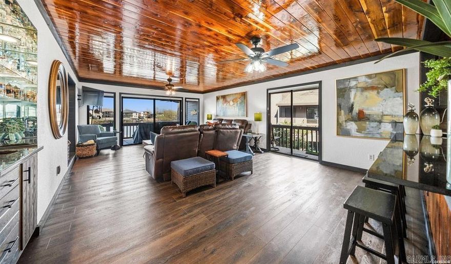 South Shore LAKE FRONT Beauty has been updated with a fun and cozy Lake Cabin vibe.  2BR/2BA waterfront condo with covered boat dock directly in front of your unit has granite counter tops, new floors throughout and new appliances. This fully furnished property offers an open floor plan, modern finishes, and custom built-in twin bunk beds for added sleeping capacity. Enjoy amazing, unobstructed waterfront views from the large private balcony—perfect for relaxing or entertaining. Located in a gated community for added privacy and security. Whether you're dreaming of quiet mornings by the water or lively summer gatherings, or adventures at Oaklawn this property is ready to become your personal lake haven.  Alternatively,  Short-term rentals allowed with no permit required, making this an excellent turnkey investment opportunity.  This wonderful community also offers swimming pools and tennis courts for your off lake pleasure.  You can decide how you want to use it and start ENJOYING Lake Hamilton and Hot Springs right away!