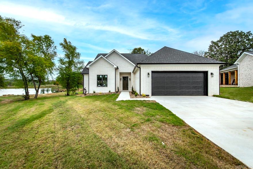 Would you like a lake view on your back porch with your morning coffee?  Come on in!  Custom home with many updates to include an AWESOME safe room with custom gun racking!  Some of the features that are above and beyond....gas stove, soft green painted kitchen island with quartz and gold accents, walk in pantry with barn door, gas log fireplace with shelving accents, stained beam in living area plus another kitchen pantry! Primary bedroom flows into a fabulous bathroom with oversized shower with rain head!  Bathroom also joins the laundry room for easy access! 8 ft custom front door & exterior door from primary bedroom to patio. Upstairs has game room, bedroom and full bathroom with custom shower.  Tankless HWH is an added feature!!  Propane buried for FP & stove. WATCH THE VIRTUAL TOUR!  See docsonline for home feature list.