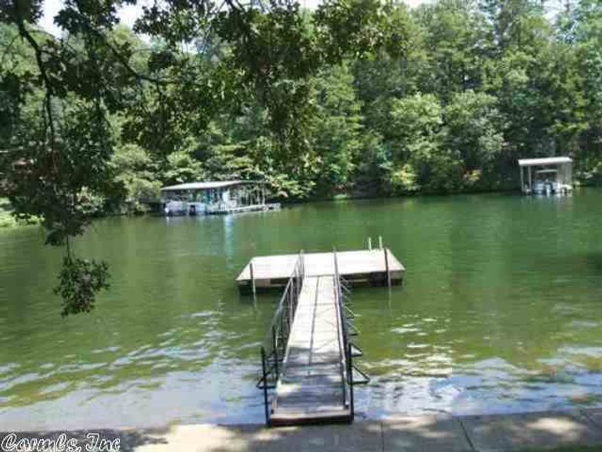 IF YOU ARE LOOKING FOR A CONDO WITH NO ONE ABOVE OR BELOW YOU, THIS IS IT. PRICED TO SELL. TOWNHOME WITH COVERED BOAT DOCK, PATIO, BBQ PIT, SWIM DOCK. GOOD DEEP WATER. WOOD BURNING FIREPLACE. FURNISHED OR UNFURNISHED