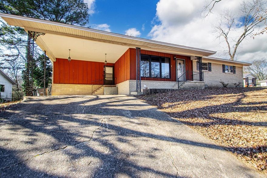 Charming 3 bedroom 2 full bath home located in the desirable lakeside School District.  This home features a spacious living area with a cozy wood-burning fireplace, perfect for everyday living and entertaining.  Enjoy outdoor gatherings on the large entertaining deck, overlooking the fenced backyard and gorgeous trees.  A hobby shop in the back adds extra storage or workspace.  convenient double carport parking.  Ideally located just minutes from Lakeside Schools and the bypass for easy commuting.  Ready to move in.  14 miles to Interstate 30 and 3.8 miles to Oaklawn Racing & Casino.  Make your appt today for this cute home.  Agents see 'Agent Remarks'