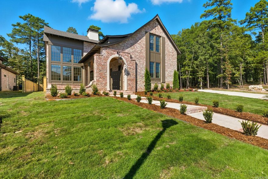 The Orle Residence is a French-inspired storybook manor reimagined for modern living. Crafted by HD Homes in collaboration with architect Salina Lambert, this architectural jewel rests within a gated and private Chenal community. Every detail has been meticulously curated, from custom wood and beam work with white oak beams to quartzite counters, honed Calacatta Vagli marble, and Bianca Rhino marble in the owner’s suite. Designer lighting from Visual Comfort illuminates artfully composed interiors, while the kitchen pairs bespoke wood finishes with Brizo Frank Lloyd Wright plumbing. The floor plan includes four bedrooms, four full baths, two half baths, a dedicated office, and a spacious media room, all flooded with natural light. Gas lanterns set a timeless tone, while the back porch extends entertaining with an outdoor kitchen and built-in heaters. Rare in both detail and refinement, this designer showcase masterpiece is truly worthy of Architectural Digest. More photos & video coming soon! Orle Residence is almost complete.