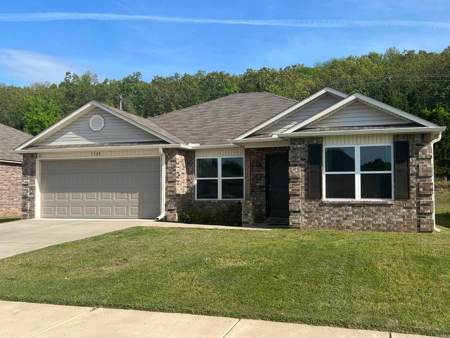 Step into comfort and style with this well-maintained home featuring a bright and open layout perfect for everyday living and entertaining.  The large living room offers plenty of space to relax and gather with family and friends.  The home includes 4 bedrooms and 2 baths with a desirable split floor plan for added privacy.  The kitchen is a standout with a walk-in pantry, stainless steel appliances, ample counter space, and room to create and entertain with ease.  The spacious primary suite is your private retreat, complete with a luxurious bathroom featuring a soaking tub, separate shower, and a large walk-in closet.  Enjoy luxury vinyl flooring throughout the main living areas with cozy carpet in the bedrooms.  Additional features include a dedicated laundry room, covered patio perfect for outdoor enjoyment and newly installed gutters already in place.  This home is the perfect blend of functionality, comfort, & style ready for its next owner.