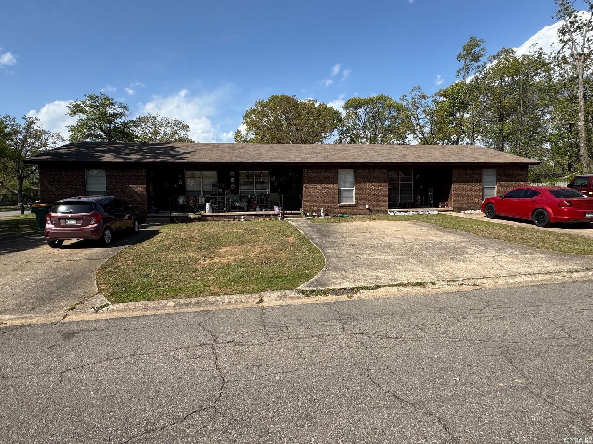All units occupied. NO showings until under contract. No walking around, residents are not aware. Property for sale "as is." Property is available to purchase with adjacent duplexes and triplexes also listed in CARMLS, which include 9001 Woodbine, 9006 Woodbine, 9007 Woodbine, 103 N Woodview, 105 Lantrip. Listing price for all six properties (14 units total) is $1,260,000.