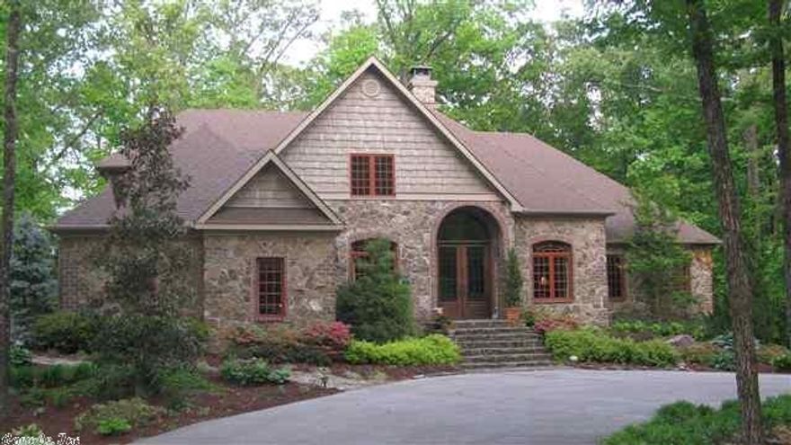 Remarkable style and quality in beautiful stone, brick and cedar home in a private, elegant small, exclusive development. There is a quaint stone bridge over a creek in front of the home. Gourmet kitchen with granite tops, SubZero refrigerator, butlers bar, and a king size breakfast room overlooking the shady small acreage back yard. Spacious family room opening to a full width deck, large formal dining room, a separate library or office or small living room. Huge main bedroom suite. 1.34 acre.