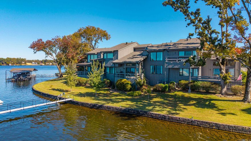 Lakefront living at its best! This unit comes with a covered boat slip with a lift. Live in one of the most desirable gated communities on Lake Hamilton. Your boat will be just steps off your covered patio. Lots of updates. New roof & gutters 2024 and porch door 2023. Granite counter tops, gas fireplace, gas stove and double oven, ice maker, kitchen island with plenty of storage, a huge pantry, crown molding, community swimming pool, parking for four, plenty of additional storage inside and out and so much more! Views of the fireworks from the master bedroom, living room, patio or boat dock! This community does not allow short term rentals. This is the one you have been looking for. Let's go see it today! Life is short. Live on the Lake!