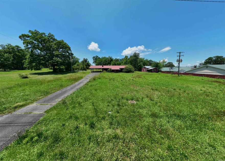 Great Opportunity in a Growing Community! This home is priced to sell and full of potential! While the interior could use some updating, it offers a fantastic opportunity to make it your own—all in the heart of a vibrant, ever-growing town.  The property includes four storage buildings and sits on a spacious lot, giving you plenty of room to expand or create the backyard of your dreams. It's zoned commercial, offering extra flexibility—live in it, renovate it, or even explore future business possibilities if desired.  Whether you're a first-time buyer, an investor, or someone looking for a home with space and eventual income making potential, this property is a smart buy in a location that keeps getting better.