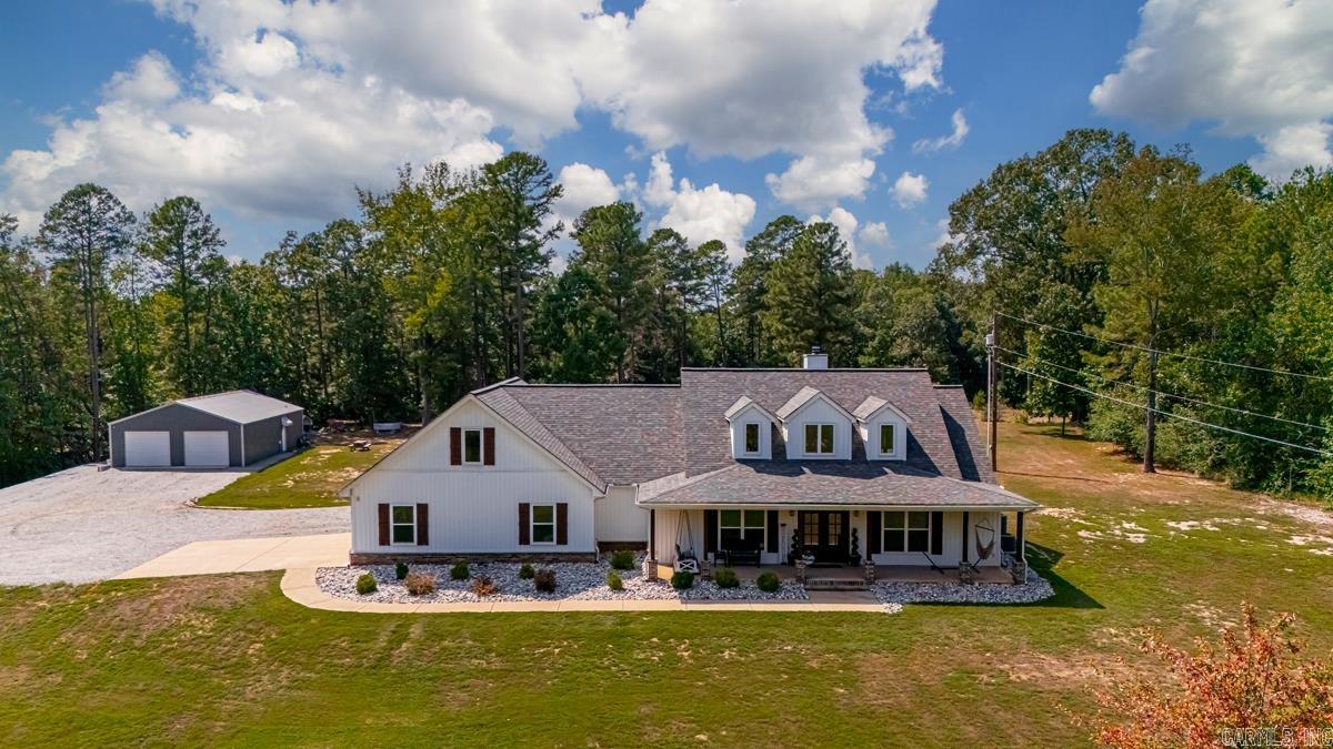 Modern Country Living on over 3.5 acres with shop + guest studio in beautiful Bauxite! Welcome to the perfect blend of space, style, and versatility. Built in 2019, this 3400+ sq ft home offers room to live, entertain, and enjoy the outdoors, all on 3.55 acres of privacy just minutes from town. Step inside to an open floor plan where the living, dining, and kitchen areas flow together seamlessly-perfect for family gatherings or hosting friends. With 4 spacious bedrooms, three of which feature private en suite bathrooms-providing a retreat-like atmosphere for family and guests alike. Expansive living area and abundant natural light elevate the home's warm yet country character! A true highlight of the property is the impressive 30x50 shop, perfect for storage, hobbies, or business ventures. Attached is a well appointed 30x16 studio apartment with a kitchenette and full bath, ideal for extended family, overnight guests, or a private retreat. Set against a backdrop of mature trees and open land, this estate offers a seamless blend of tranquil, comfortable living. This home features stained concrete floors throughout. Seller offering a $10,000 flooring allowance with acceptable offer.