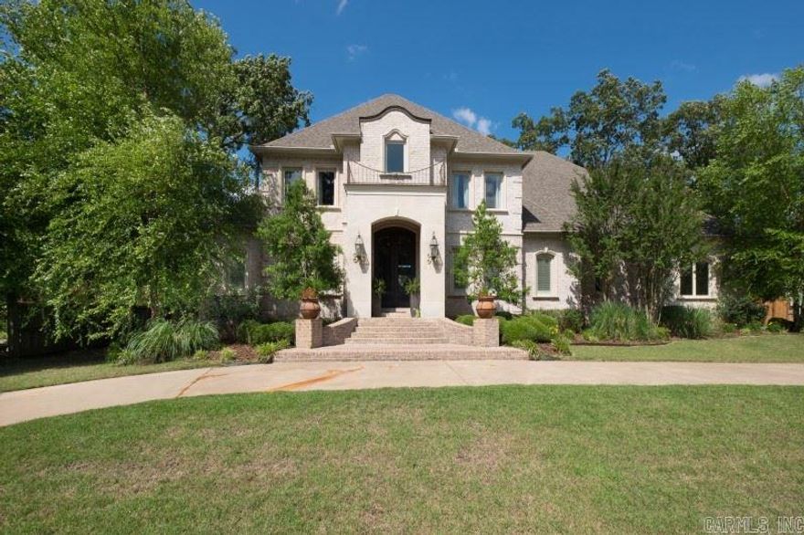 Elegant, spacious and entertainer's dream! Circular drive, antique brick and crafted iron doors. Versatile floor plan w/4 living areas and possible 6th bedroom. Plantation shutters, hand scraped hardwoods, dual staircase and open floor plan. Pella windows, wine room, wet bar and cozy hearth room. Chef's kitchen- 6 burner Viking, 2 laundry rooms, and in-law suite. Game room with mini kitchen, and upstairs den. 2 Balconies overlooking in-ground pool and water feature. Custom finishes galore. 2007 roof & HVAC.