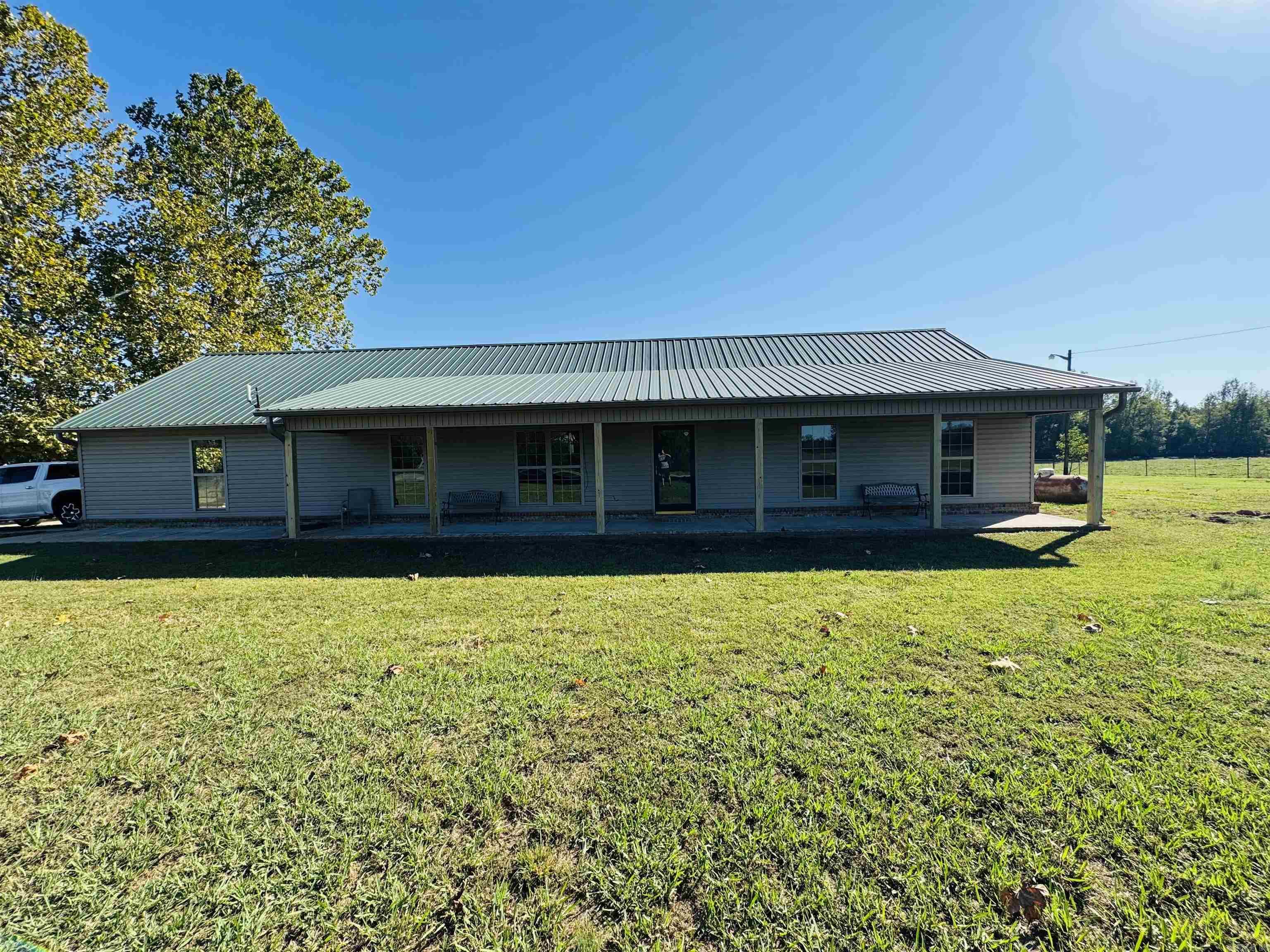 Beautiful Ranch style home sitting in the middle of open pastures now available! This 4 bedroom 2 bath offers a covered front porch that stretches across the entire house with recent updates including paint, deck, ceiling fans throughout as well as new LVP floors and tile just installed. Nice open layout with big mud/laundry room and wide doors with no stairs for handicap accessible if needed. Has an oversized 2 car garage and detached storage room as well!