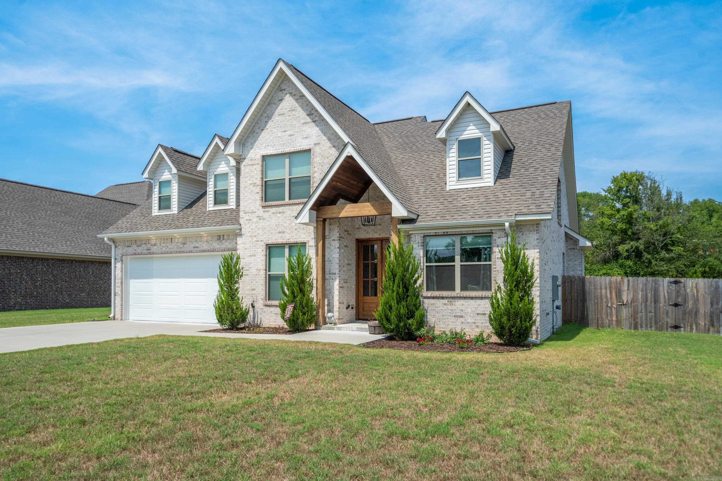 Newly built in 2022, this cozy and beautiful modern rustic two-story home is located just 5 minutes from Oaklawn, 10 minutes from Downtown Hot Springs, 45 minutes from Little Rock, within the Lakeside School District in a safe neighborhood and no home owners association! A spacious 2,829 square foot layout includes custom eye-catching details, numerous windows for natural light, live edge countertops, an all-rock gas fireplace, and rustic wood beams among its five bedrooms, 2.5 bathrooms, den and an office. On the first floor, there is an open concept with an office, a spare bedroom, and a vaulted master suite with an oversized soaking tub, a walk-in shower, and a private toilet room. An approximate 500 square foot bonus room and two additional bedrooms (one with a spacious walk-in closet)can be found on the second floor. LVP flooring throughout, carpet upstairs, tile bathrooms, a built-in dog kennel beneath the stairs, front and back yard sprinklers, a fully fenced backyard, and a covered patio with a gas line are some additional features. This stunning home was built with no expense spared and been kept in immaculate condition! Make this gorgeous house your home!