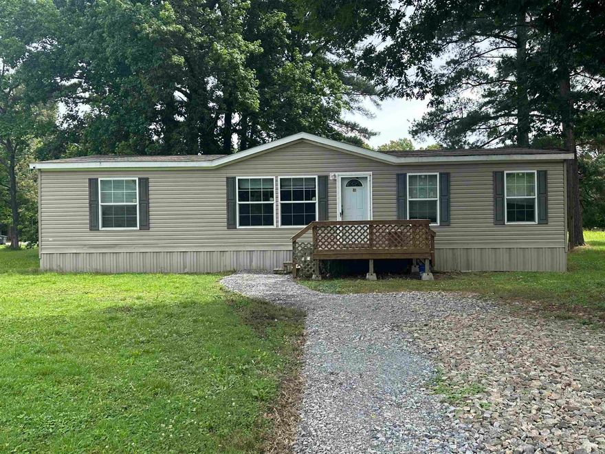Mobile Home on a small city lot with city water and sewer.  Home is blocked up on concrete runners with necessary tie downs to qualify for multiple loan types.