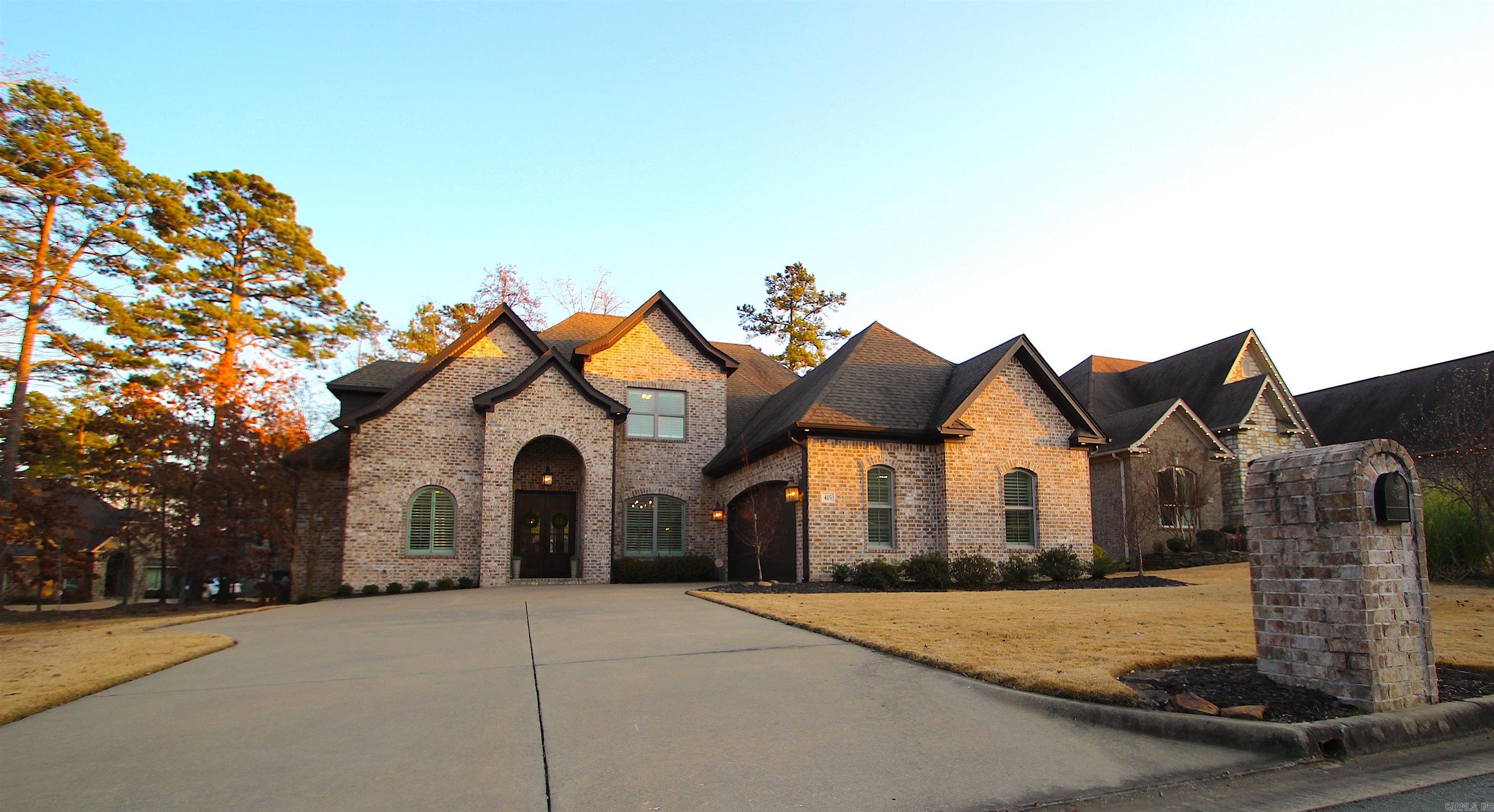 Welcome to an extraordinary residence in prestigious Chenal Valley, positioned on a spacious corner lot surrounded by green space. This impeccably designed home spans 3,478 sq ft, offering 5 bedrooms and 3 1/2 bathrooms, thoughtfully arranged across two levels. The main-level primary suite, intelligently crafted office, and a versatile fifth bedroom turned media room provide versatile spaces for comfort and functionality. Two living areas, each featuring a fireplace, create a cozy ambiance, while the covered porch, deck, and patio provide serene outdoor retreats amid the lush trees and privacy. Noteworthy features include a level lot for easy maintenance, French drains for efficient drainage, and oversized garage for golf cart storage or workbench for the active lifestyle. The large kitchen and butler's pantry cater to culinary enthusiasts, and abundant storage throughout the home ensures practical convenience. Completing the package is a whole-home generator, offering peace of mind in any situation. Schedule a showing to experience the exceptional lifestyle that Chenal Valley has to offer.