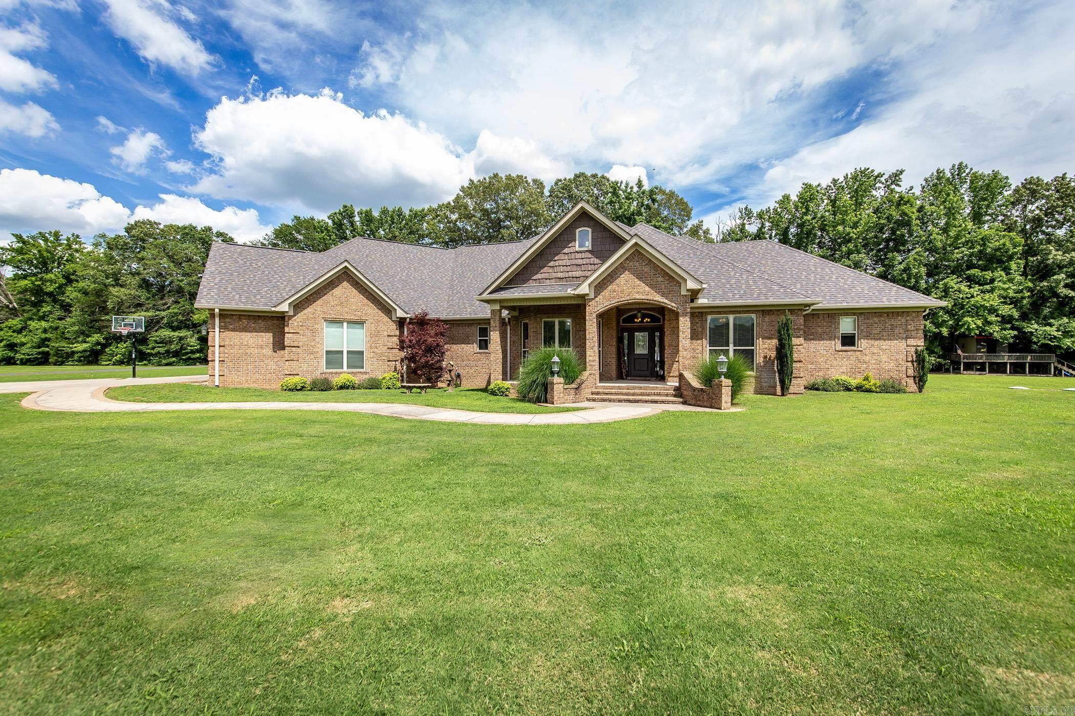 Beautiful custom built home located on 30 acres. Large open floor plan, custom built ins and paint. Soaring ceilings, granite countertops, wet bar, ice maker, lots of cabinets and storage with lower pull outs. Kitchen is a chef's dream, new cooktop, dishwasher has never been used, walk in pantry, island, custom spice racks, breakfast bar and dining area. Good size guest rooms on main floor share a Jack & Jill bath. Huge primary suite w/sitting area, walk in closet opens in laundry room. Certified safe room/gun storage. Primary bath has walk in shower, tub and every inch of storage possible. Christmas room has built ins for added convenience w/ storage/wrapping area. Formal dining area has lots of windows and can be used as an office. Patio has built in kitchen, grill & heated/cooled half bath.Upstairs you w/ find a massive bonus room/bedroom/walk in closet. Also on this property you w/ find an in law quarters/guest house with a kitchen, laundry room, bedroom and full bath that is handicapped accessible. Large porch area for enjoying the deer playing in the field. Carport and storage building. Whole house generators on both homes and each home has its own septic. Agents see remarks