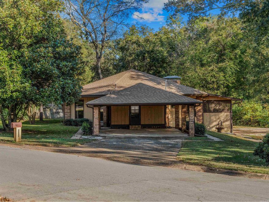 Welcome to a truly unique architectural gem! This one-of-a-kind, octagon-shaped home is a remarkable find, offering 1,884 square feet of distinctive living space.  Step inside to discover a cozy yet functional layout. The home features a modest kitchen and dining room that flow into a large, inviting living room—perfect for relaxing or entertaining. You'll find two comfortable bedrooms, one full bath, and a spacious covered porch, ideal for enjoying quiet mornings or cool evenings.  Situated on a well-maintained lot of over one-half acre, the property offers a beautiful yard in a quiet, established neighborhood. A two-car carport provides convenient parking. This home is a rare opportunity to own a piece of unique design and a tranquil retreat.