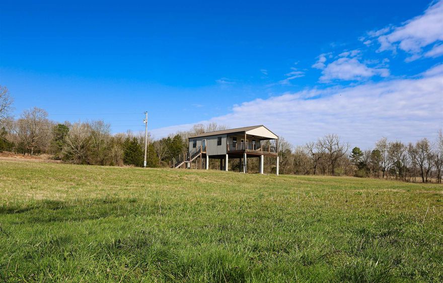 Experience the ultimate Ozark retreat with this nearly new 1-bedroom, 1-bathroom cabin perched overlooking the scenic Southfork River. Spanning approximately 840 sq. ft., the home features an efficient, modern layout with luxury vinyl flooring and two mini-split units for year-round climate control. The interior comes turn-key ready, including the range, refrigerator, and washer/dryer. Step outside onto the expansive walk-out deck to enjoy breathtaking river views and easy access to world-class fishing, canoeing, kayaking, and swimming right from your own backyard. Situated on 10 acres of mostly open pasture and hay ground, this property is a versatile gem perfect for a hobby farm, cattle, horses, or a private homestead. With highway frontage and ample acreage, there is significant potential to subdivide for additional building sites. The land is fully equipped with rural water, electricity, and a private septic system, all while benefiting from remarkably low annual taxes of just $589.59. Located only minutes from Salem, this riverfront estate offers the perfect balance of secluded country living and modern convenience.