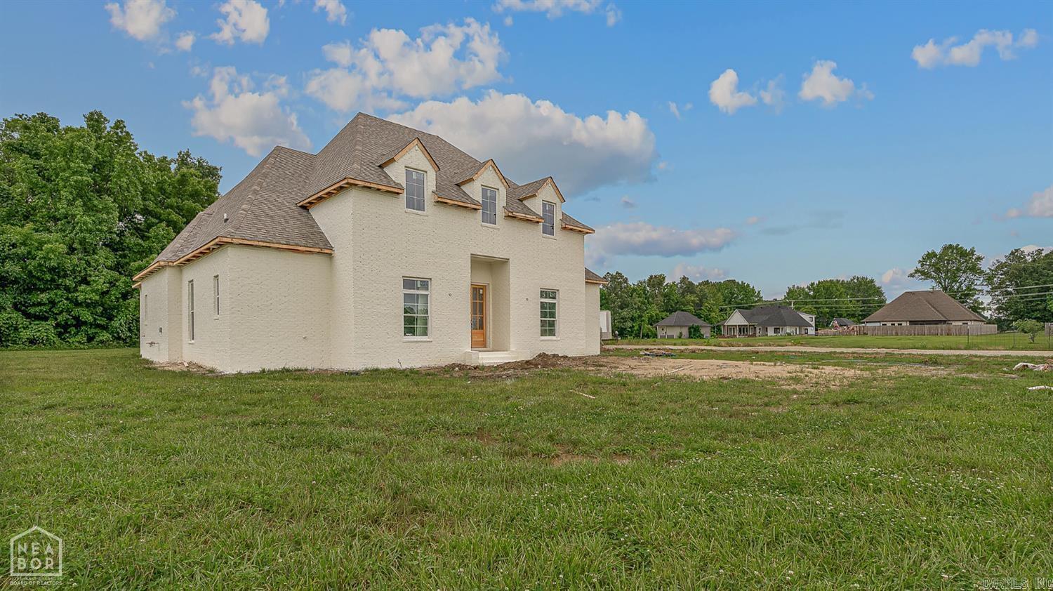 Welcome to this stunning new construction home offering luxury, space, and modern style on 1.52 acres! With 4 beds, 3 bathrooms, and nearly 3,000 square feet of open concept living, this beautifully designed home has everything you're looking for. From the moment you arrive, the crisp white painted brick exterior and 3-car garage make a striking first impression. Inside, you'll find a large, light-filled layout perfect for everyday living and entertaining. The heart of the homes is the spacious eat-in kitchen, complete with a breakfast bar, ample counter space, and a seamless flow into the living area anchored by a gorgeous gas log fireplace. Step outside to enjoy the covered patio, ideal for relaxing evenings or hosting guests. With high-end finishes, thoughtful design, and plenty of room to spread out, this home is the perfect mix of comfort and elegance all on a beautiful piece of land. Don't miss your chance to make this dream home yours!