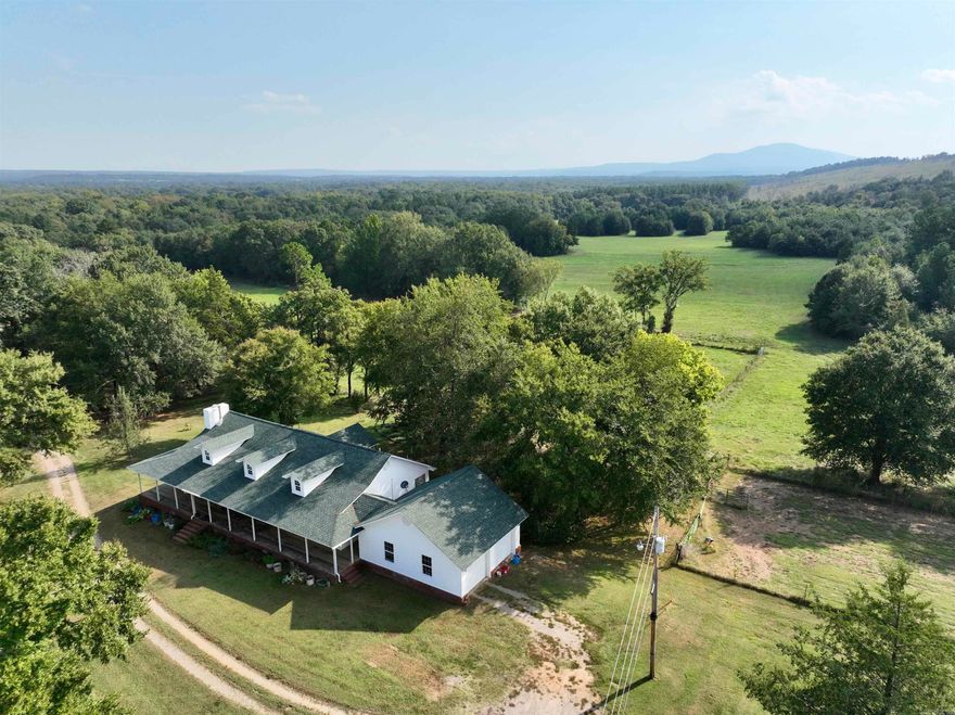Discover a once-in-a-lifetime opportunity to own a breathtaking cattle and horse farm nestled in the heart of Arkansas' picturesque landscape. Located just a short drive from Boonville, AR, this serene property offers unparalleled privacy and seclusion, sitting at the end of a quiet road. This ranch features a beautiful, custom-built home designed for comfort and elegance. The three-bedroom, two-bath residence boasts an open floor plan with a vaulted ceiling in the living room, creating a spacious and airy atmosphere. Enjoy the warmth and charm of a woodburning stove on cool winter nights, while high-speed internet ensures you stay connected. The home is powered by a water well and equipped with solar panels, reducing utility costs and promoting sustainability. Step outside to be greeted by spectacular panoramic views of Magazine Mountain. The property includes a large barn with horse stalls, an oversized corral with multiple working pens, and ample pastureland to meet all your grazing and hay needs. The land features a desirable mix of open areas and hardwood timber, making it ideal for both cattle and recreation.
