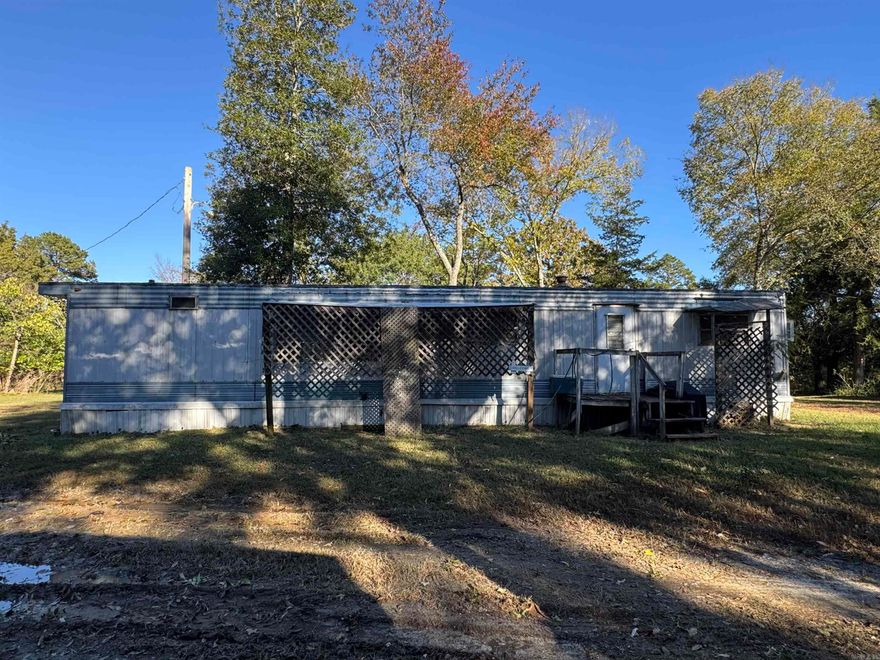 This 10-acre property in Hatfield, Arkansas, is an existing mobile home park with excellent potential for future income. It currently includes 10 mobile home hookups, each equipped with its own electric meter, city water, and sewer connection. The section where the hookups are located is cleared, while the back portion of the property is wooded, offering a mix of open space and natural privacy. There are currently five mobile homes on the property that will need to be repaired or removed, allowing flexibility for new development or improvements. A legal easement runs along the right side of the property up Rowe Lane, providing access to the neighboring property. This property sits just outside of city limits, offering more flexibility while still being conveniently located. With existing infrastructure in place, this is a great opportunity for someone looking to create or expand an investment property. A layout of the property is included in the listing photos, showing the location of all hookups, the existing mobile homes, and the easement.