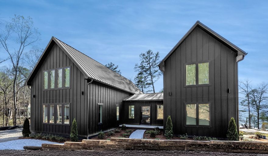 It really doesn’t get better than this—one of the best lakefront & lakeview properties in Tannenbaum & the entire Greers Ferry Lake area. Gentle sloping lake path to the shoreline makes it easy to moor your boat, zip up to the house for lunch, welcome guests or lounge on the shore watching jaw-dropping sunsets. Newly constructed in 2025, this home has it all—6 bedrooms (4 King ensuites, 2 lakeside w/expansive sliders & Juliette balconies) & 5.5 baths. Main level offers 2 ensuites, welcoming foyer, dining room & great room/kitchen w/wall of glass overlooking the water, plus ½ bath, hidden butler’s pantry/coffee bar/laundry, screened porch & lakeside deck. Just off the main level is a large game room for kids & adults. Upstairs #1 has 2 BRs, 1 BA & 2 lofts; Upstairs #2 has 2 ensuites & loft sitting area. Professionally decorated & furnished, it’s truly move-in ready with thoughtful finishes throughout & inviting spaces designed for gathering. Low-maintenance siding & roof, Andersen windows & tile decking add ease of ownership & long-term durability. Close to Tannenbaum amenities—tennis, pickleball, basketball, boat launch, airstrip & golf—all just a short walk or golf-cart ride away.