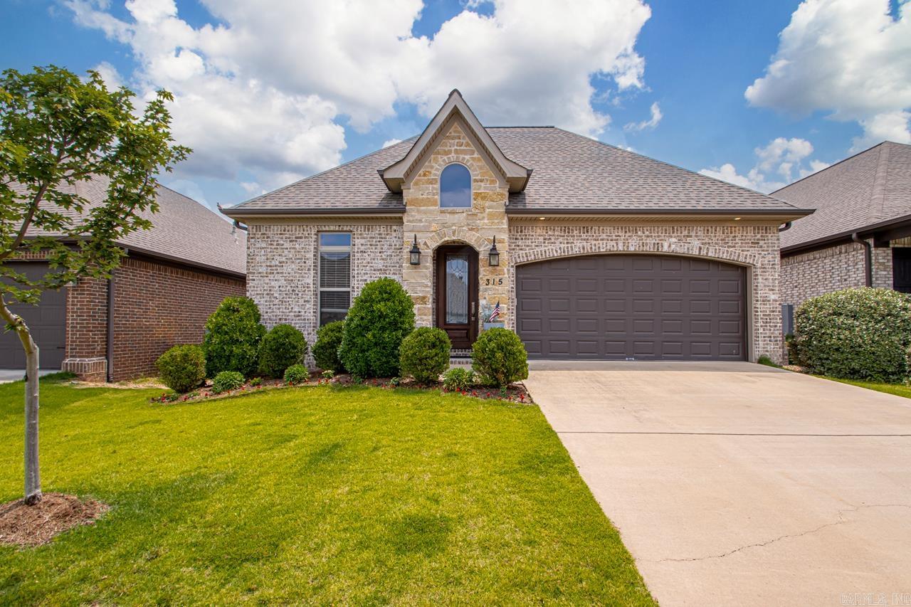 Step into this 3 br, 2ba, home where thoughtful upscale construction meet modern design. Soaring 10ft ceilings and 8ft wood doors create an open airy feel, while rich LVP flooring flows throughout the main living areas and spacious primary suite. The gourmet kitchen is, complete with a walk-in pantry, gas cooktop, and elegant cabinetry. Enjoy cozy evenings by the fireplace in the living/dining room. Step outside to a beautifully landscaped backyard featuring a privacy fence, patio, sprinkler system, and added greeneryāideal for outdoor living. The oversized storage room in the garage offers the perfect spot for lawn equipment or extra belongings. Located in a sought-after community with a neighborhood pool and park, this home blends comfort, convenience, and style.