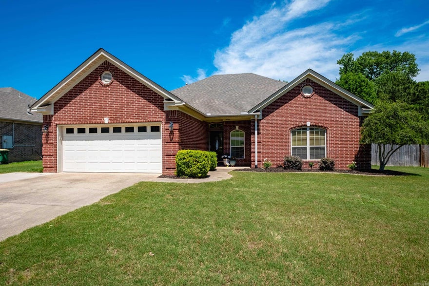 This well maintained, one-level, 3 bed / 2 bath home in the Oakbrooke Subdivision features beautiful hardwood floors and a large open living room- featuring tray ceilings, a gas log fireplace, and abundant natural light. The updated kitchen offers granite countertops, stainless steel appliances, a breakfast bar, and great workspace for everyday cooking or entertaining.  The split floor plan provides privacy, with a spacious primary suite that includes an office nook, double closets, a walk-in shower, granite countertops, and a relaxing jacuzzi tub. Two additional bedrooms share a full bath on the opposite side of the home.  Outside, enjoy a flat backyard with an extended patio, storage shed, and peaceful views—this property backs up a wooded area for privacy. A widened driveway offers extra parking convenience. Move-in ready and perfectly located near Sherwood’s parks, schools, and amenities.