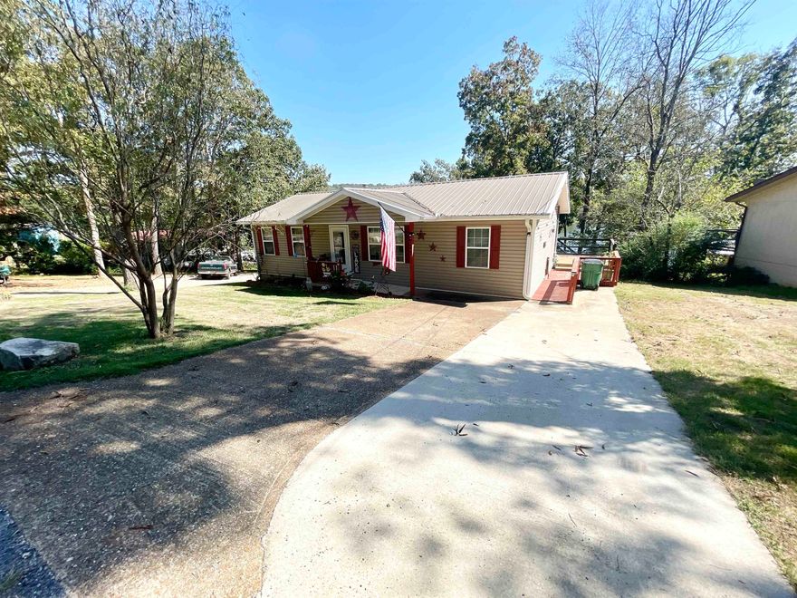 Beautifully remodeled 3 bed 1 bath LAKEFRONT home on the famous "LAKE CHEROKEE" in Cherokee Village AR!  This FRESHLY remodeled home offers everything you need for the perfect lakehouse living. Inside, you’ll find new vinyl plank flooring, solid wood doors, and a luxurious walk-in tiled shower with glass doors. The kitchen shines with quartz countertops and a deep stainless sink, ideal for cooking and entertaining.  Enjoy outdoor living on the 38-foot deck (built in 2022) with peaceful lake views. A new sliding glass door, metal roof, and new septic system (installed June 2025) add lasting value. The basement offers storage or expansion potential, and the chain-link fenced backyard is perfect for pets or children.  With a gentle slope to the water—not steep—you’ll love easy access for fishing, kayaking, or relaxing on your private dock. This move-in ready lakefront home is a rare find in Cherokee Village, AR, perfect as a full-time residence, weekend getaway, or vacation rental investment.